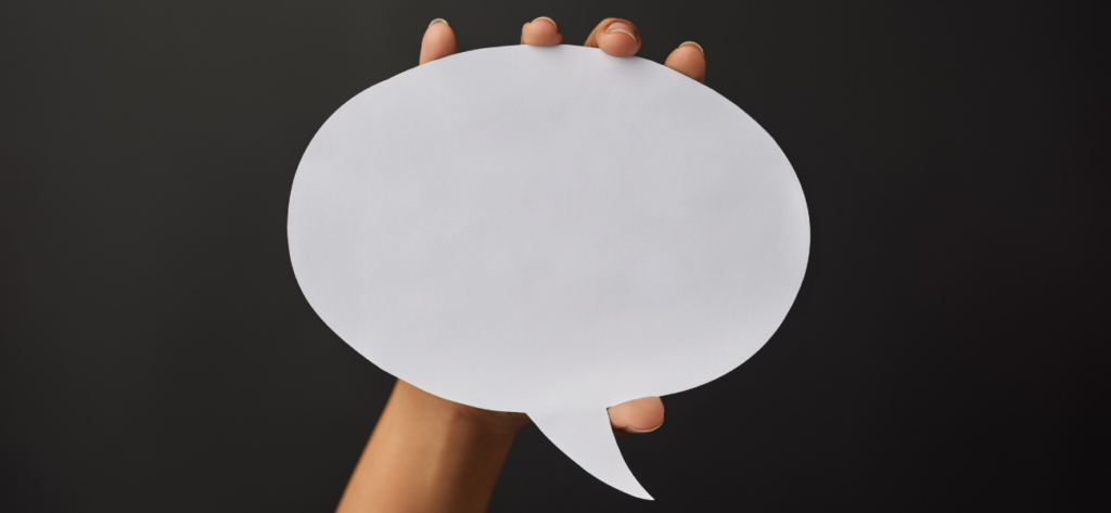 Sprechblase, die von einer Hand hochgehalten wird